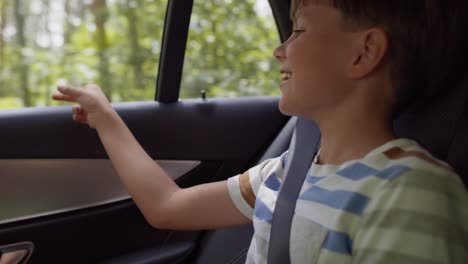 video of boy looking out the car window