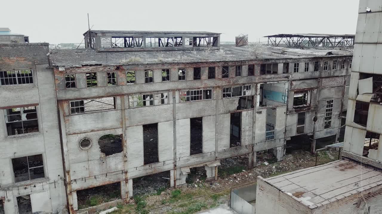 Aerial view of an old factory ruin and broken windows. Old industrial building for demolition.