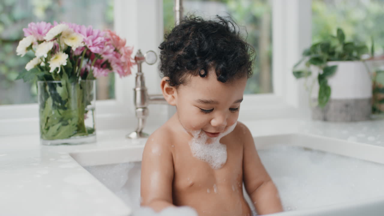 happy baby bathing funny toddler taking bath in kitchen sink having fun with soap bubbles 4k