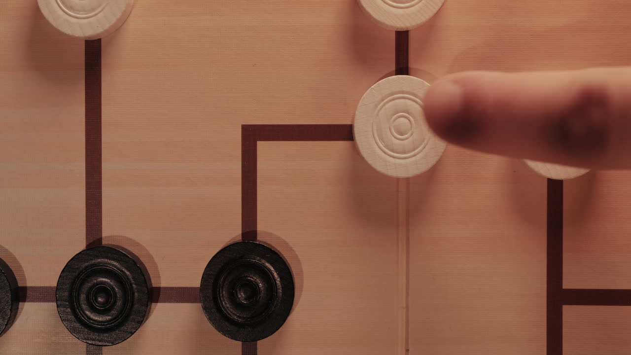 Hand Moving Pieces on a Strategy Board Game