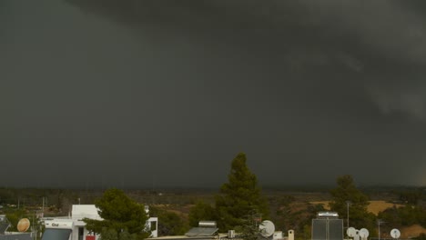 Slow-right-pan-footage-of-heavy-dark-storm-clouds-over-Parnitha-and-Penteli-mountains,-Greece