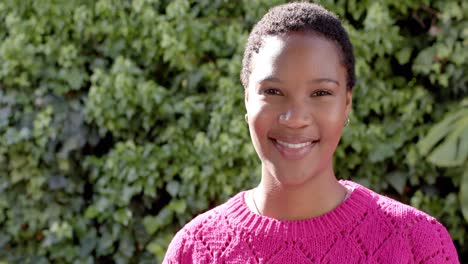 Portrait-of-happy-african-american-woman-in-sunny-garden,-slow-motion