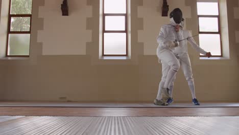 fencer athletes during a fencing training in a gym