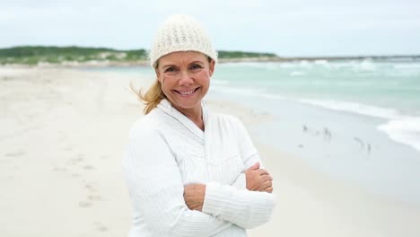 retired woman on the beach looking out to sea