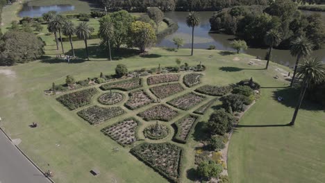 man and woman meeting at rose garden in centennial park - sydney, australia - aerial drone