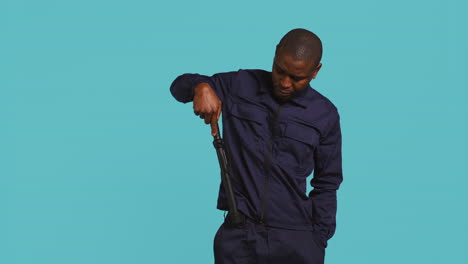 portrait of security agent removing baton from belt to secure assigned post