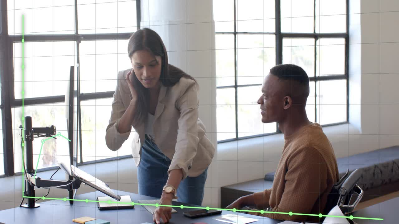 Woman tapping tablet when man reaching green graph following taps across desk while reviewing sales