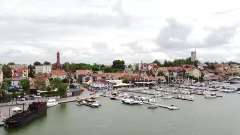 drohnenflug aus der luft über die fußgängerbrücke, das schönste der touristischen stadt im ermland-masuren mit blauem meer und winzigen schiffen und yachten im sommer