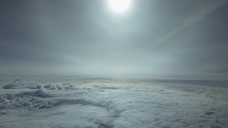 POV-flying-over-a-layer-of-clouds-at-supersonic-speed-with-a-dazzing-sun-light