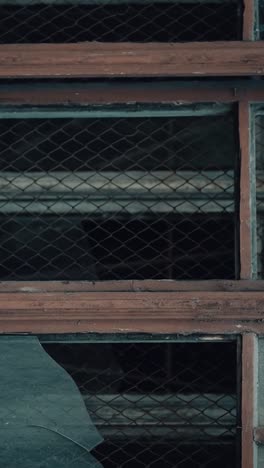 old, abandoned building windows with rusty metal grating