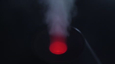 working a humidifier with a red circular light in the middle