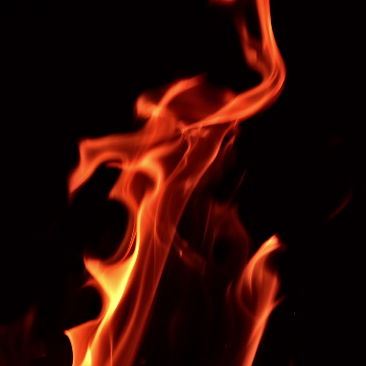 Fire flames rising in the air. Bonfire burning in the dark. Close up