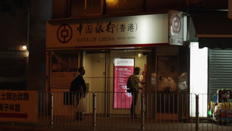 Static-shot-of-a-man-taking-money-from-an-ATM-machine-in-Hong-Kong