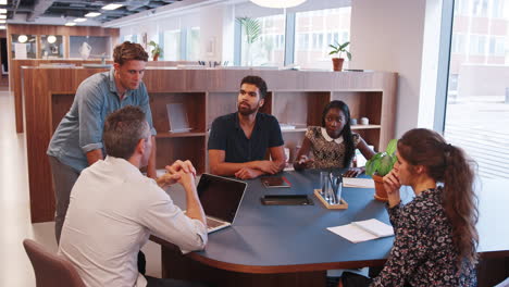 Casually-Dressed-Businessmen-And-Businesswomen-Having-Informal-Meeting-In-Modern-Office