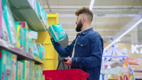 man shopping for diapers in a supermarket