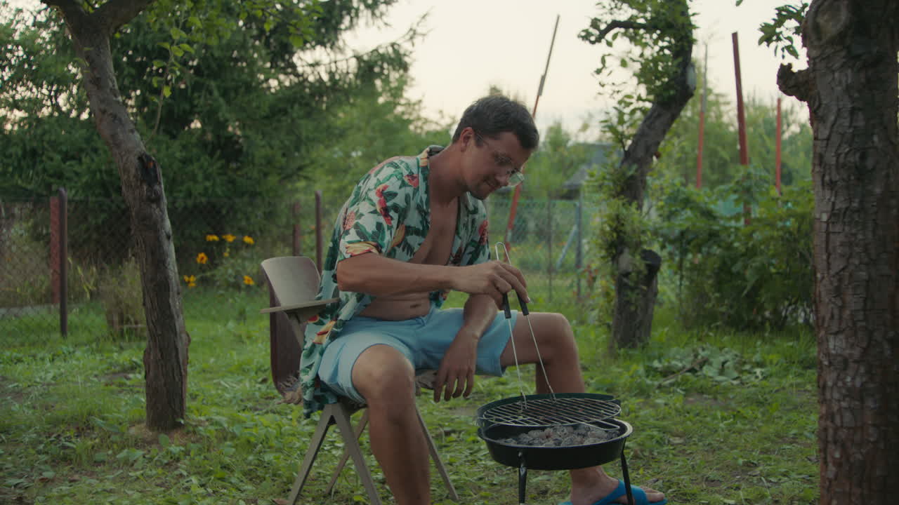 Man grilling in a garden