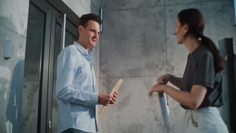 man receives and signs for a package from a delivery person
