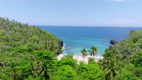 Aerial-approaching-shot-of-beautiful-golden-beach-with-turquoise-Caribbean-sea-in-tropical-scenery---Playa-Onda,-Dominican-Republic