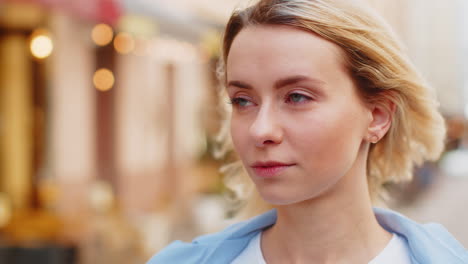 Close-up-portrait-of-happy-young-satisfied-woman-face-smiling-friendly-open-eyes-glad-expression