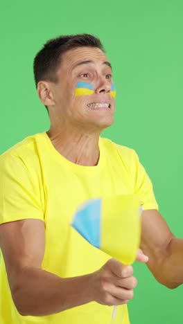 Nervous ukrainian supporter during an exciting match looking away