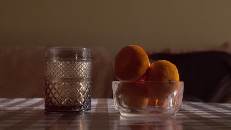 hand picks up a fresh fruit from the bowl close up