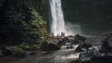 bali, spring 2020 in 1080 60p, daytime, cinematic drone flight a slow motion horizontally from left to right flight in front of a waterfall clos over the river