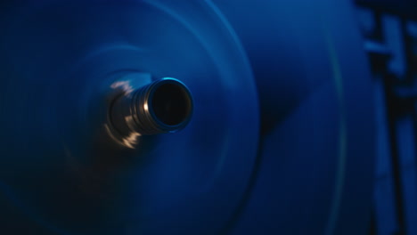 a vintage tape recorder spinning spools in a blue light
