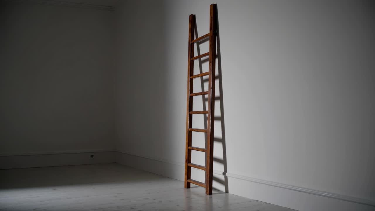A minimalist video scene featuring a wooden ladder leaning against a white wall, captured from a low