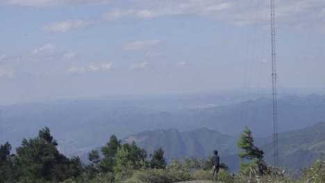 a man is standing in the wind to see the scenery