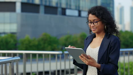 businesswoman using digital tablet in urban setting
