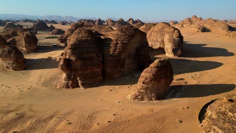 drone shot endless desert landscape with huge rocks and sand dunes