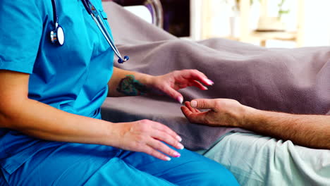 Close-up-shot-of-nurse-taking-old-man-hands