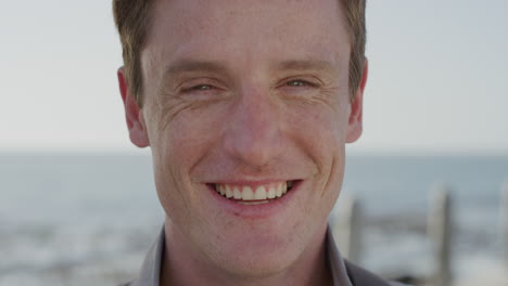 close-up-portrait-handsome-young-red-head-man-laughing-happy-student-enjoying-successful-lifestyle-relaxing-on-warm-summer-day-seaside-slow-motion