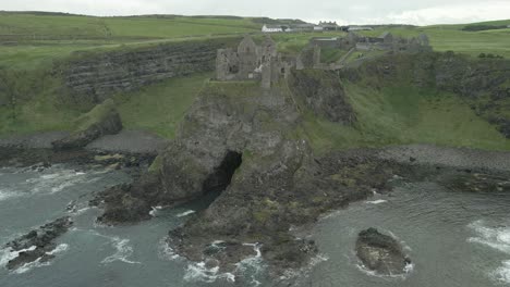 Ruins-of-Dunluce-Castle-on-Mermaid's-Cove,-Northern-Irish-Coast---Aerial