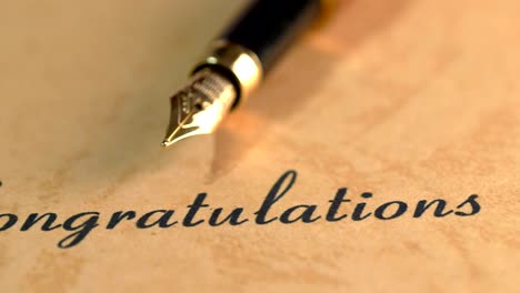 fountain pen on congratulations text