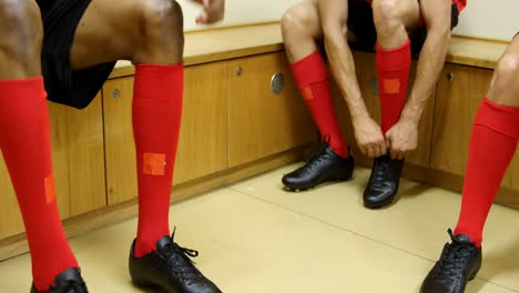 athletes tying shoe lace in the locker room 4k