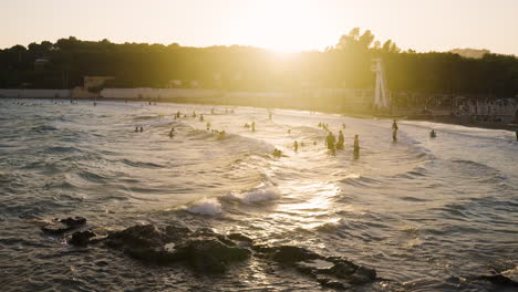 sunset beach scene with people bathing