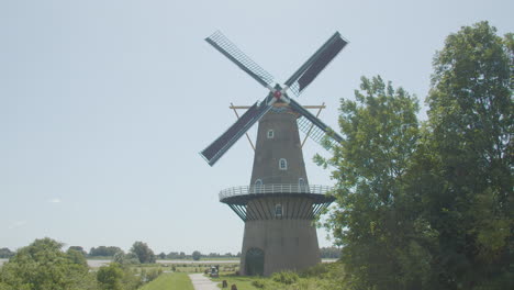 beautiful old dutch windmill spinning its blades in the wind