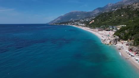 Colorful-Palette-of-Beach-Bliss-and-Azure-Seas,-Embracing-the-Beauty-of-the-Albanian-Riviera-and-its-Mountain-Villages