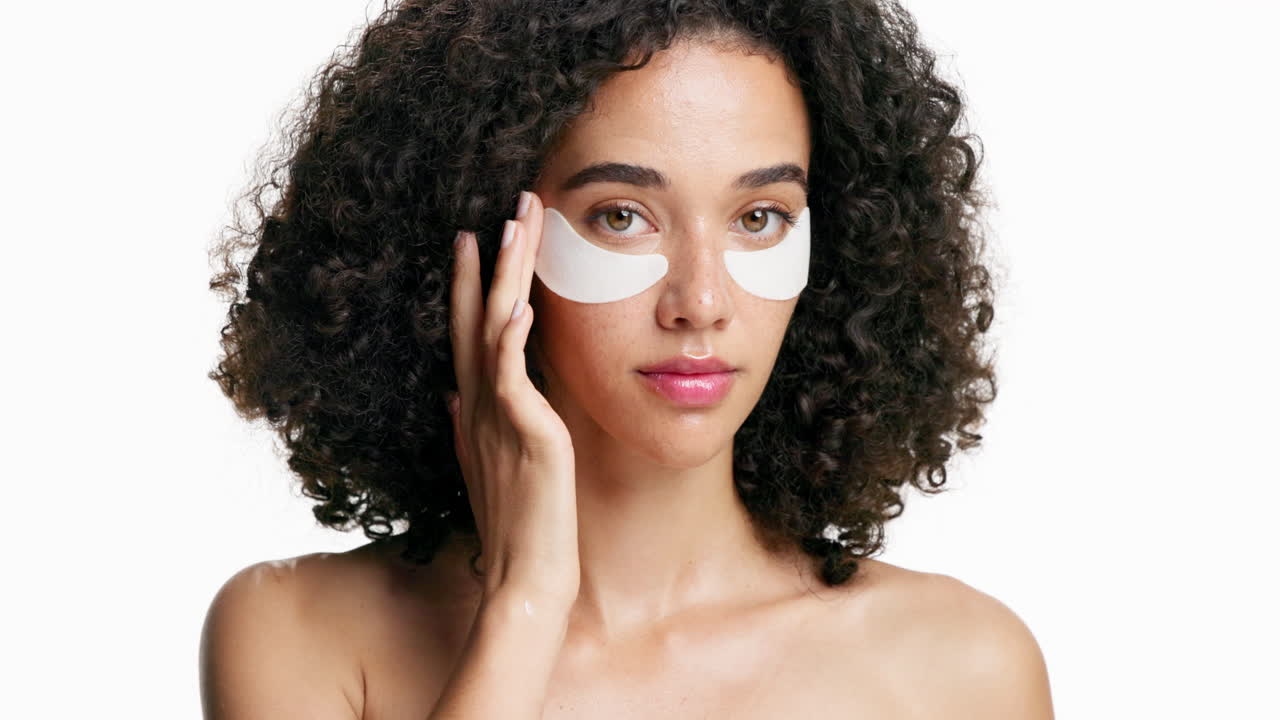 Woman Applying Eye Patches