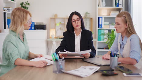 Female-Employees-Present-Documents-to-Director