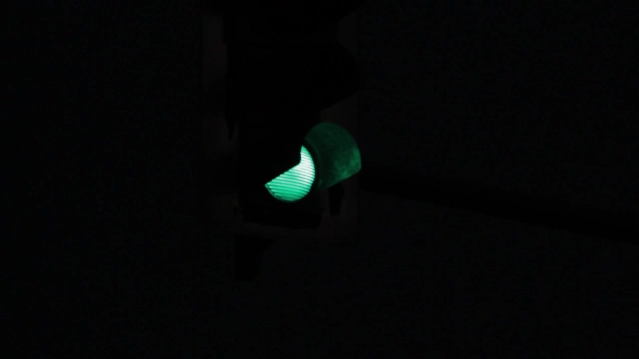 夜間、ぼかしから鮮明になる青信号