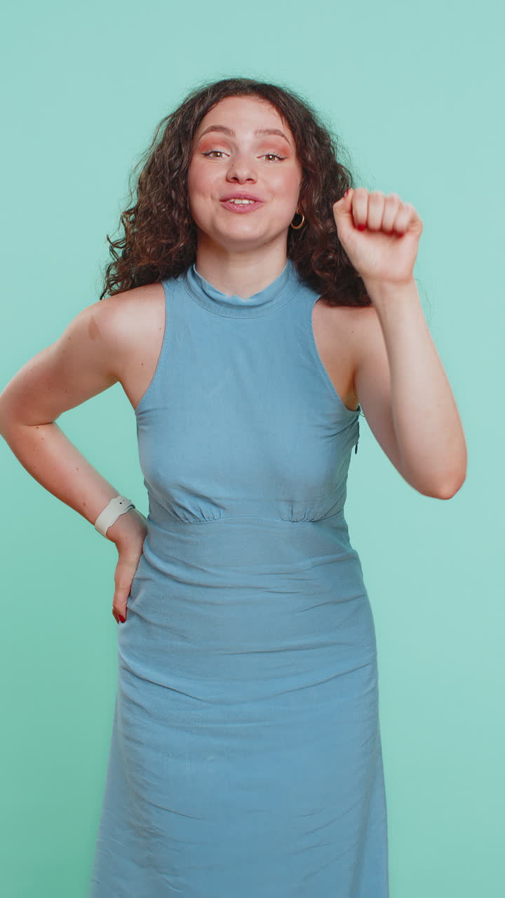 Excited young woman knocking door gesture asking who is at home feeling embarrassed no idea