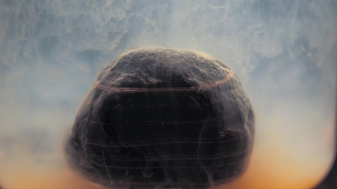 Colored paint floating around beautiful layered rock.  Shot with the Sony a7iii.