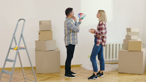 couple choosing paint color in new home