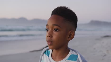 portrait of happy african american boy on sunny beach