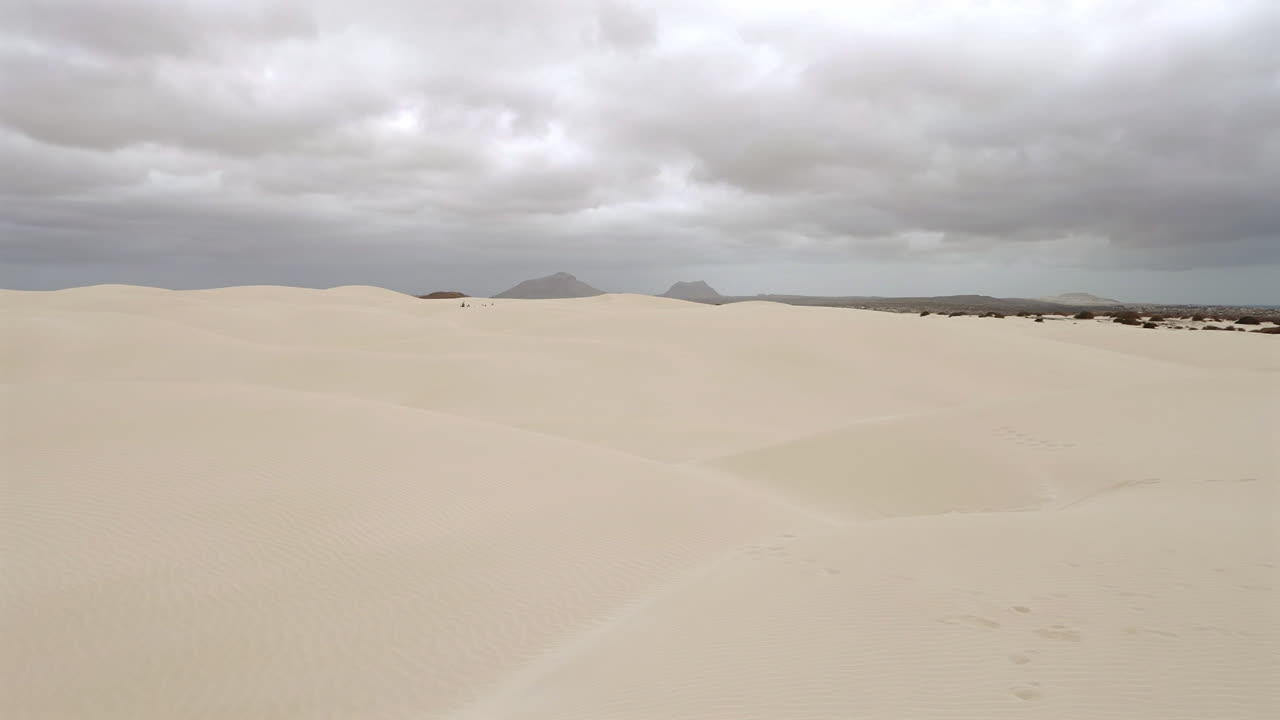 Nice sand dunes in Viana desert at overcast day, background mountains, Boa vista , Cape Verde