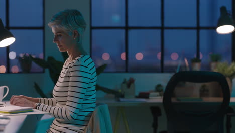 senior business woman using computer working late successful entrepreneur busy on company project dedicated mature female in start up office workspace