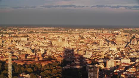 Storm-clouds-coming-over-Milan-cityscape,-view-from-above