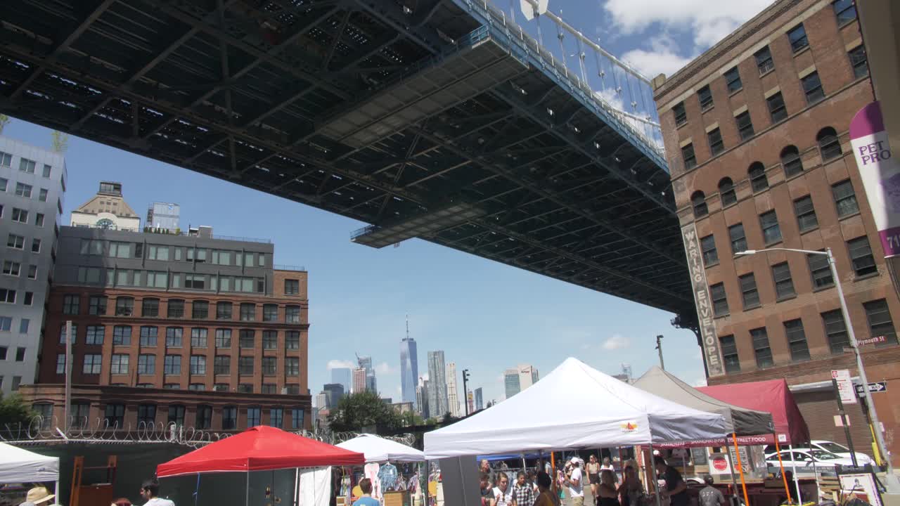 A bustling street market under a bridge in New York City